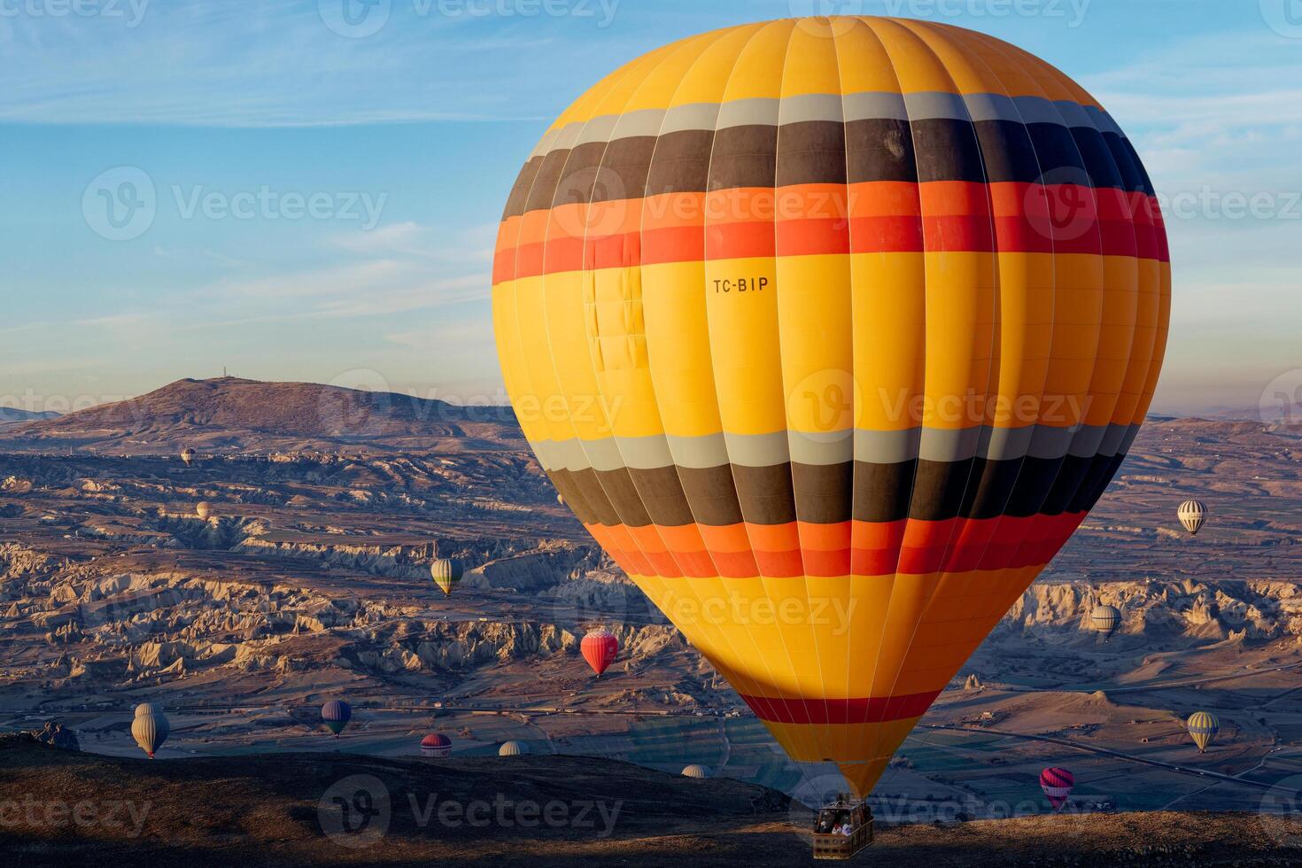 Hot air balloon flight in Goreme in Turkey during sunrise. Ride in a hot air balloon, the most popular activity in Cappadocia. Romantic and famous travel destination. photo