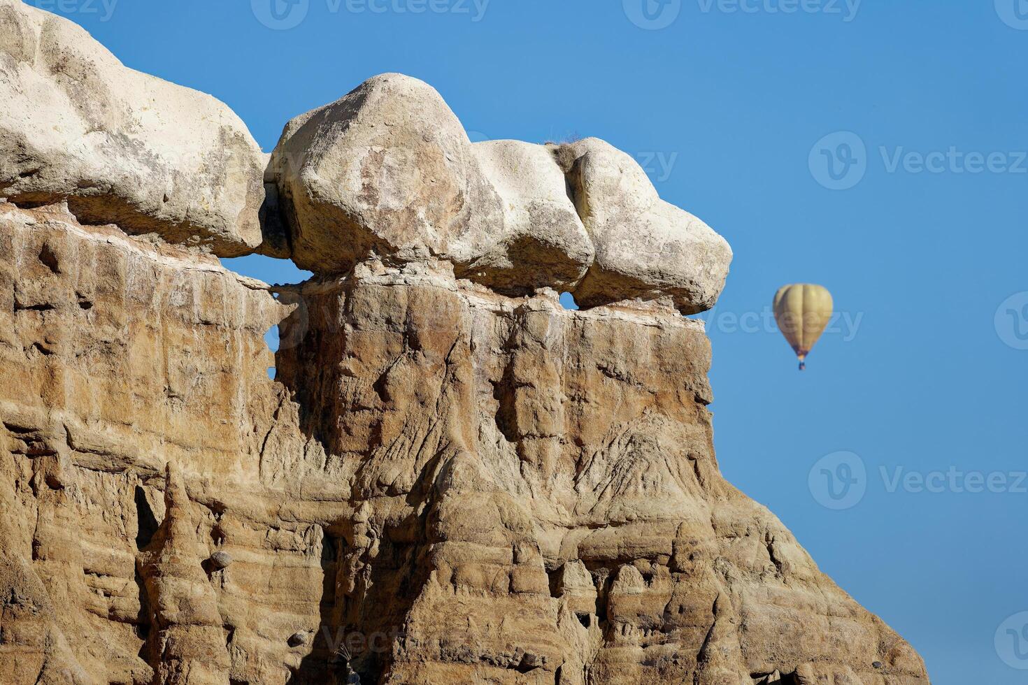 View the natural phenomenon in Cappadocia, Turkey with a hot air balloon in the back. Travel concept for Cappadocia. photo