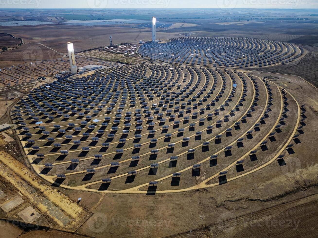 Aerial view of the Solar Power Towers PS10 and PS20 in Sanlucar la Mayor, Seville. Spain's stunning solar energy plant. Concentrated solar power plant. Renewable energy. Green energy. photo