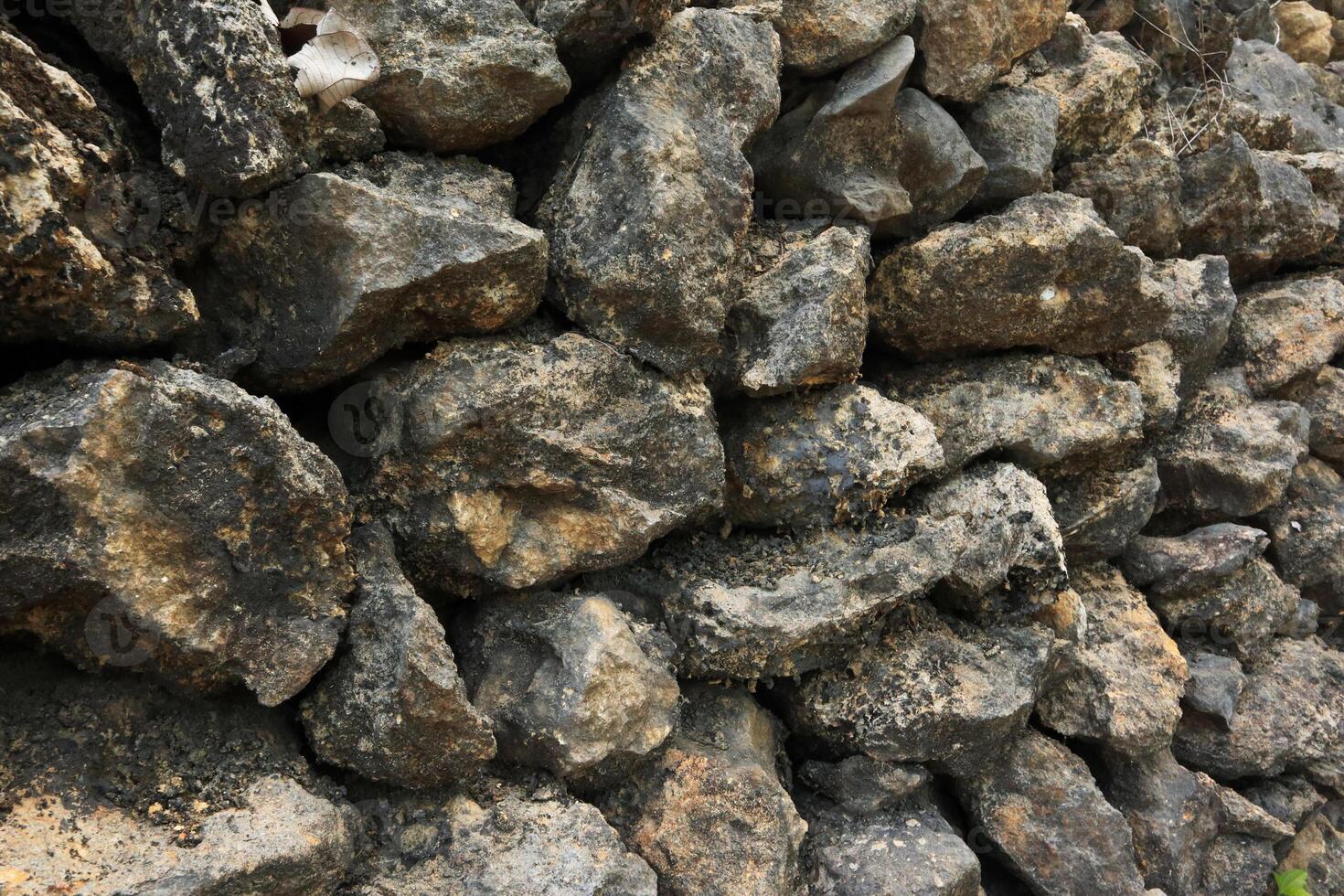 Stacked Rocks Texture, Detailed Texture of A Stone Foundation Supporting Shingle Siding photo