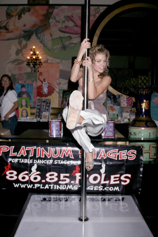 AnnaLynne McCord  demonstating her skills on a stripper pole GBK MTV Movie Awards Gifting Suites  Crimson  Opera Los Angeles,  CA May 30, 2008 photo