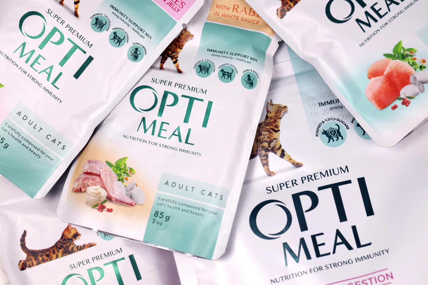 KHARKIV, UKRAINE - JANUARY 2, 2021 Optimeal cat meal packs. Optimeal is product by Kormotech LLC, a global family company, the largest producer of pet food in Ukraine photo