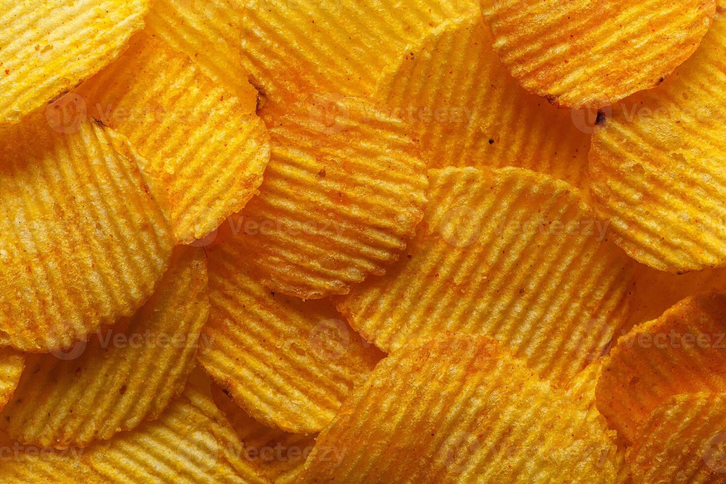 macro of beautiful corrugated yellow chips under the sun's rays photo