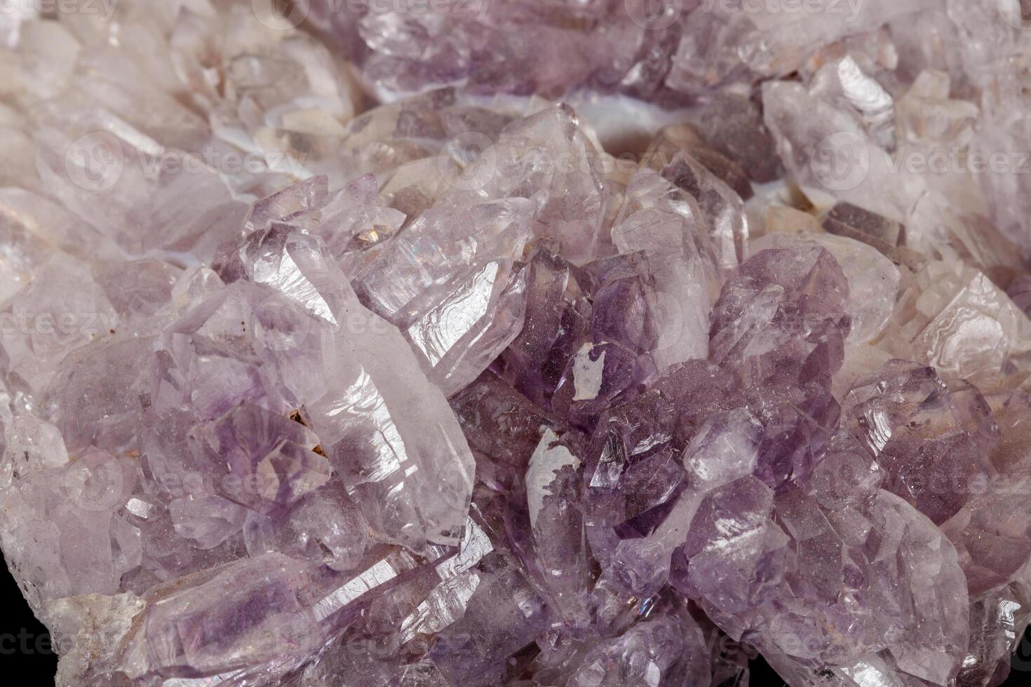 Macro of amethyst mineral stone on black background photo