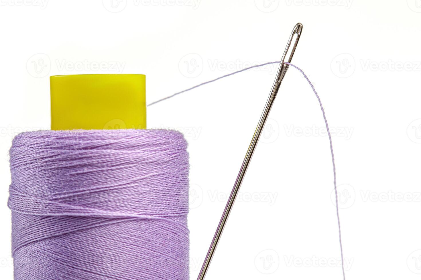 Macro skein of thread purple colors with a needle on a white background photo