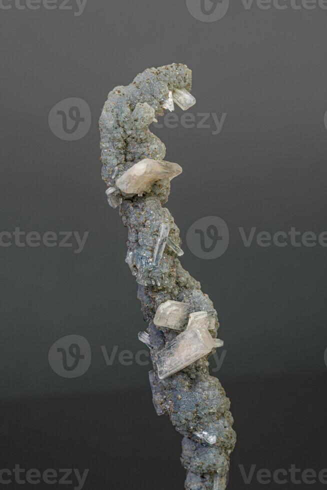 Macro mineral stone chalcedony with stelbite on a gray background photo