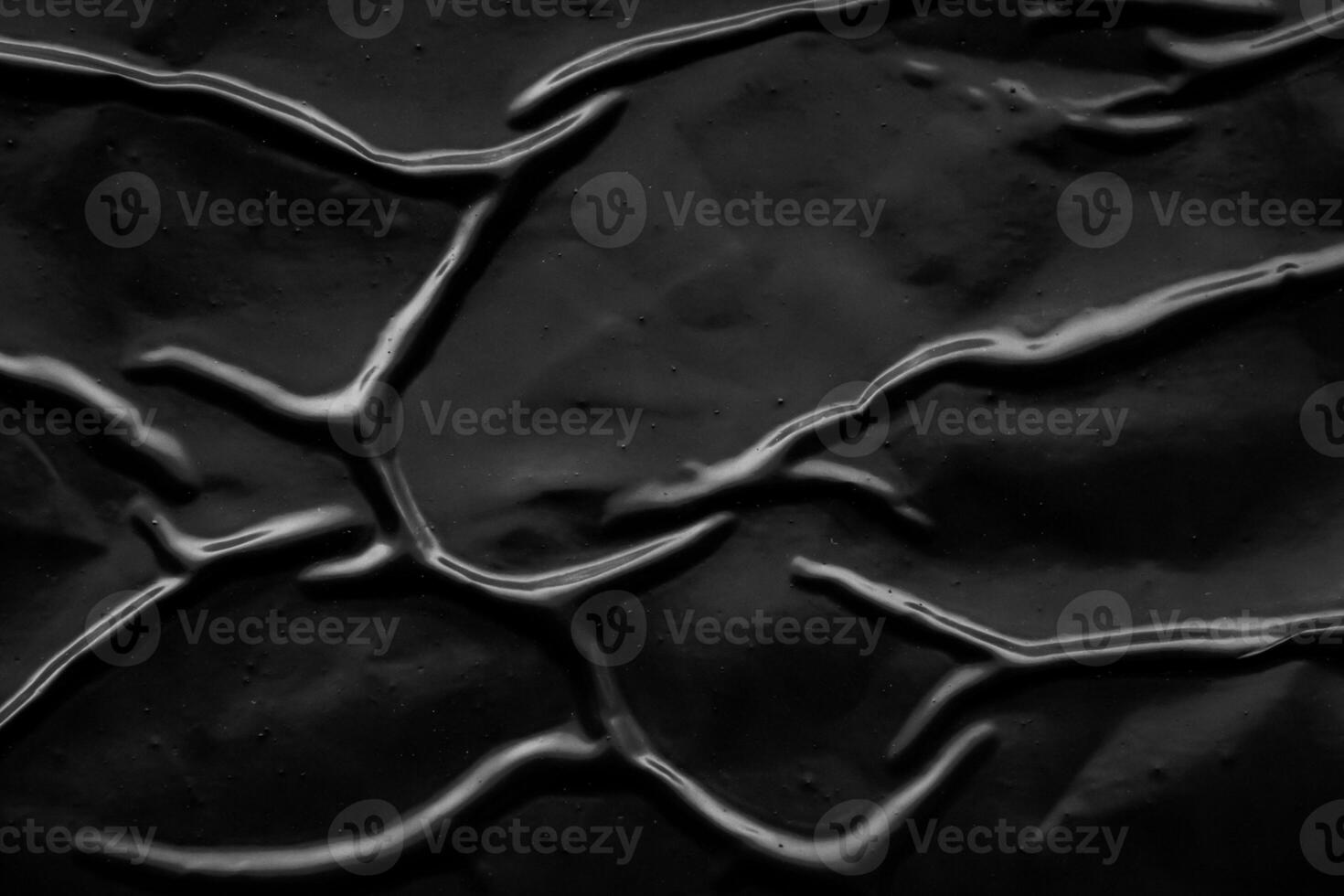 black crumpled and creased plastic poster texture background photo