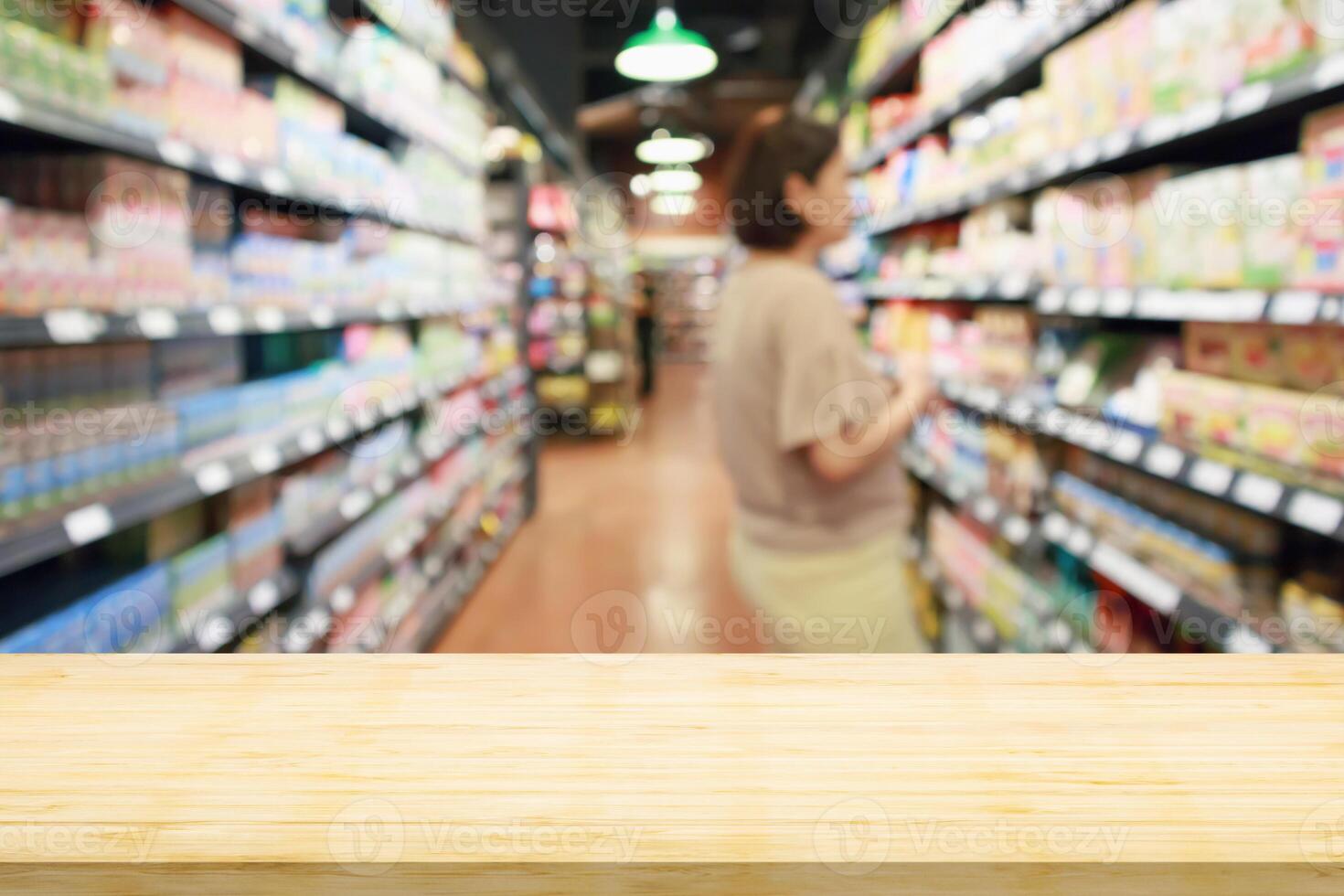 Empty wood table top with supermarket blurred background for product display photo