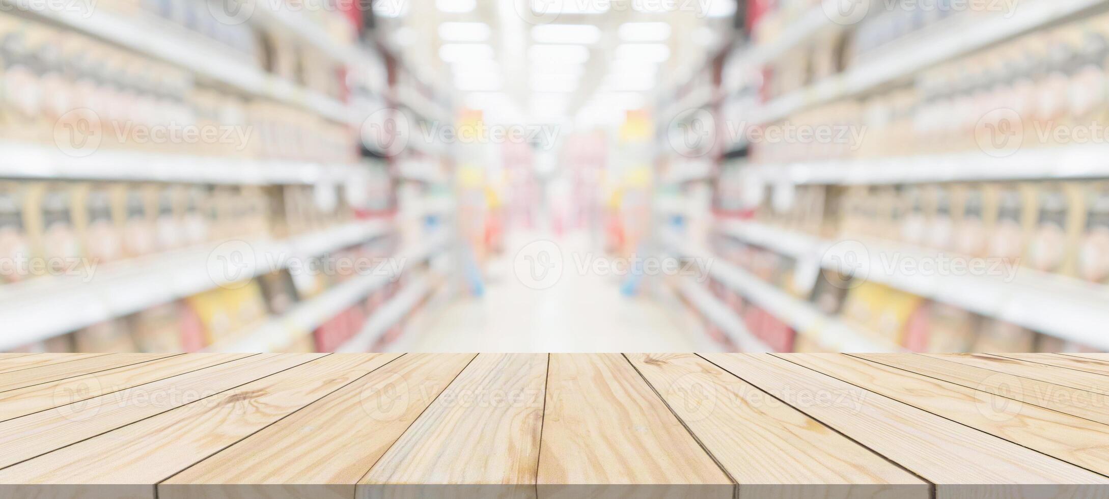 Wood table top with supermarket grocery store blurred background with bokeh light for product display photo