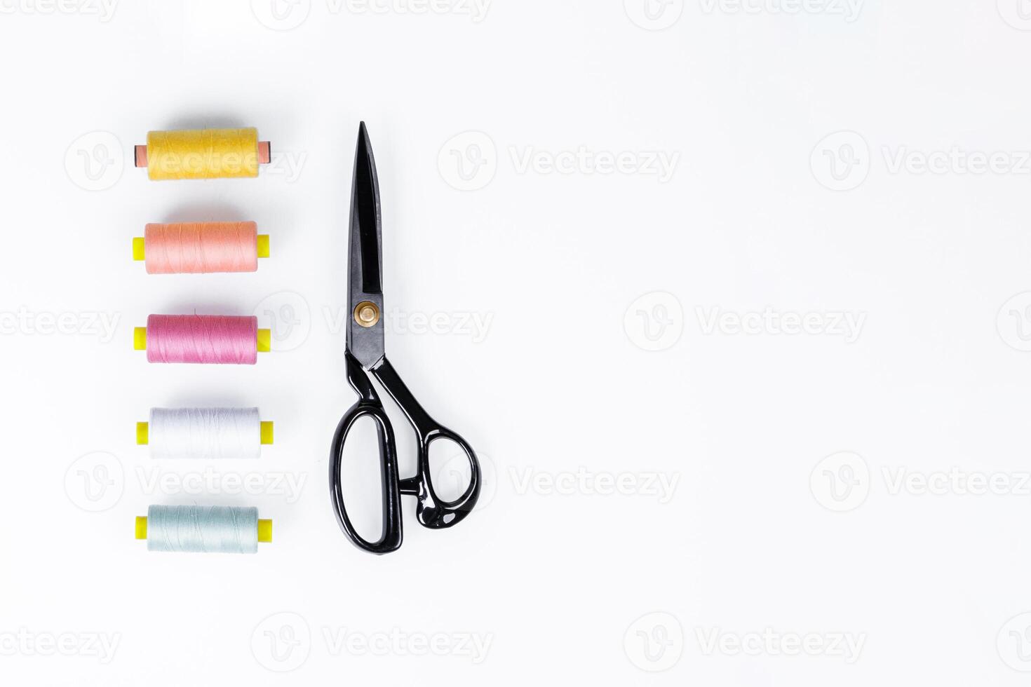 set of scissors for sewing and thread on a white background photo