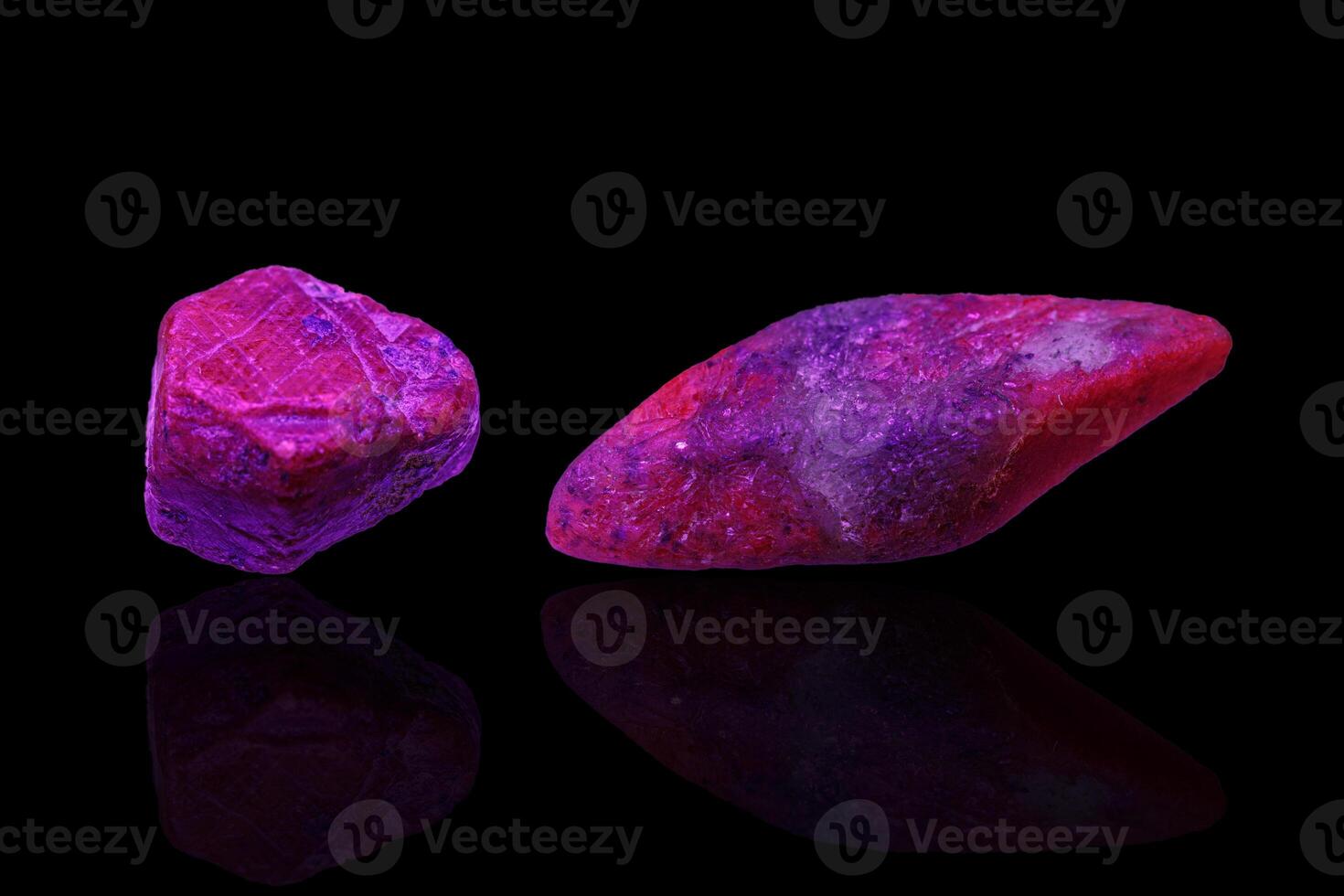 macro mineral stone ruby under ultraviolet light on a black background photo