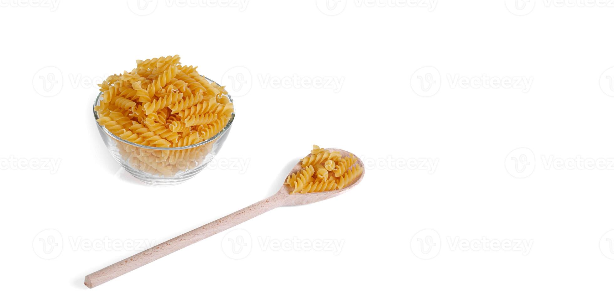 Pasta in the form of a spiral on a plate, spoon, texture, on a white background photo