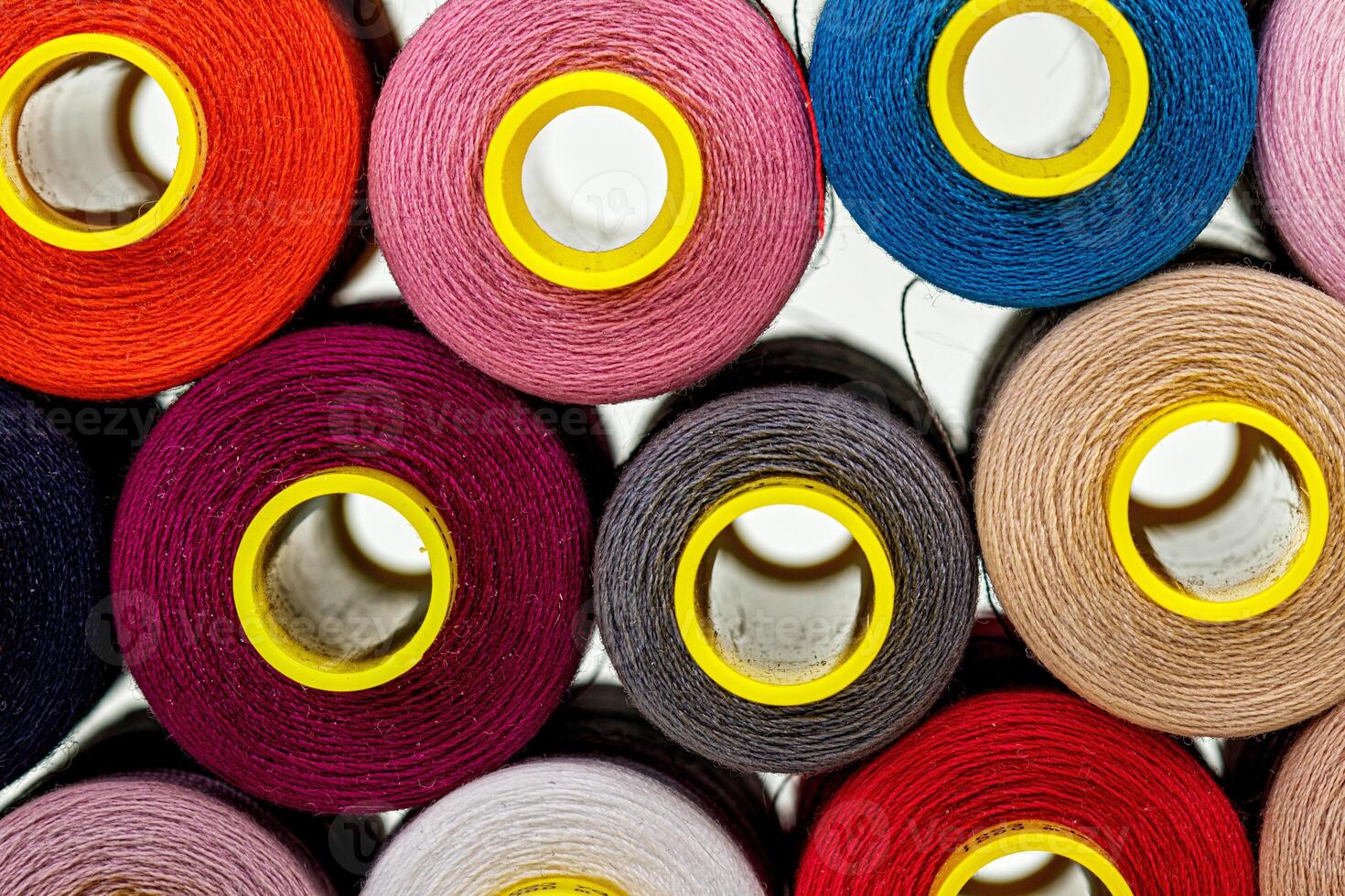 set of multi-colored spools of thread for sewing photo