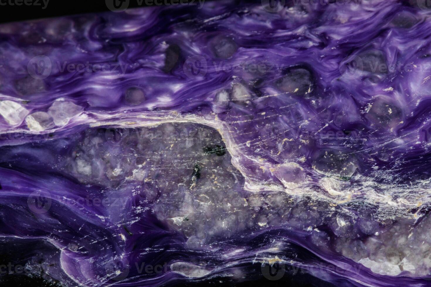 Macro stone Charoite mineral on a black background photo