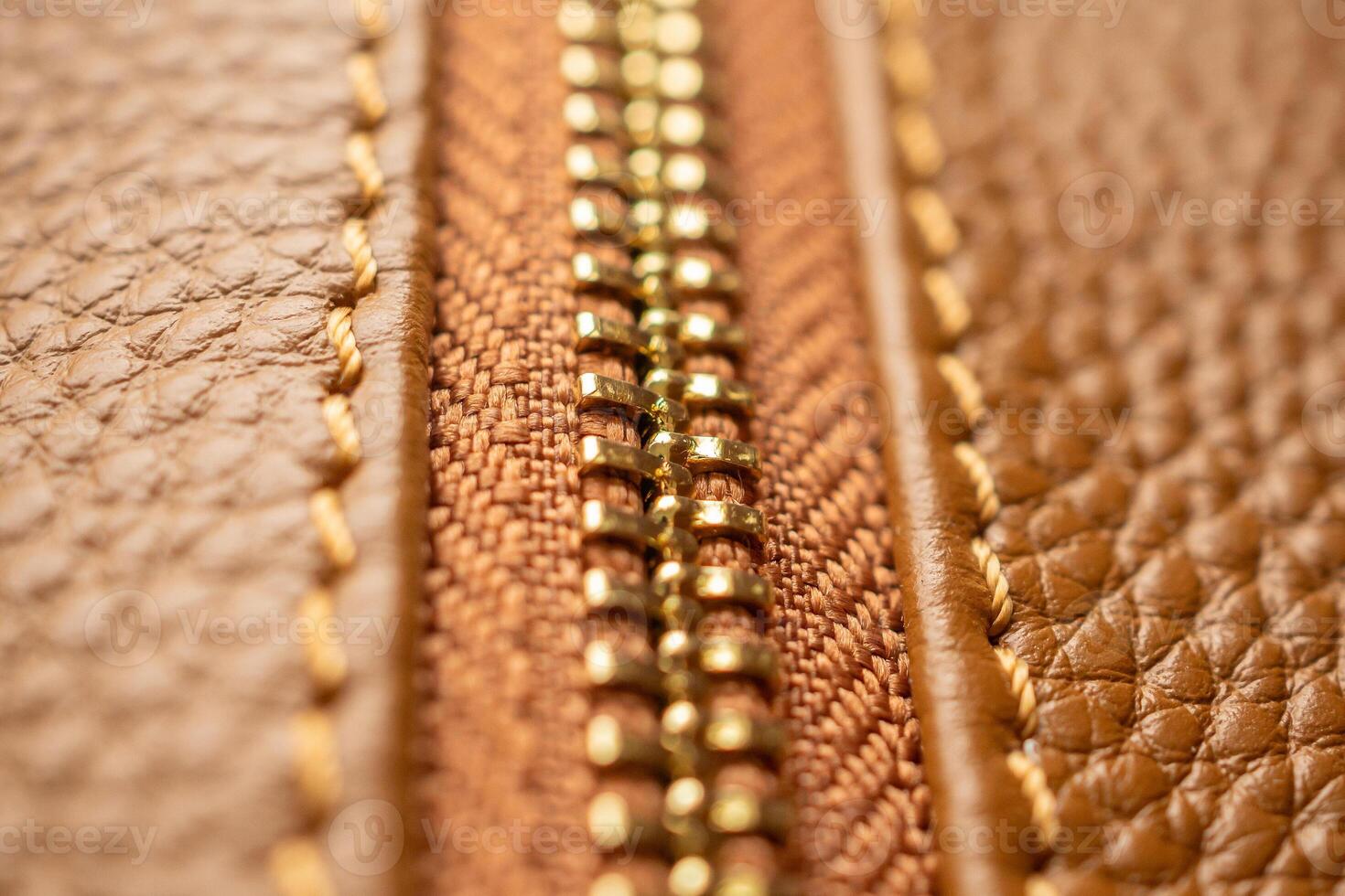 close up of zipper on brown leather bag photo