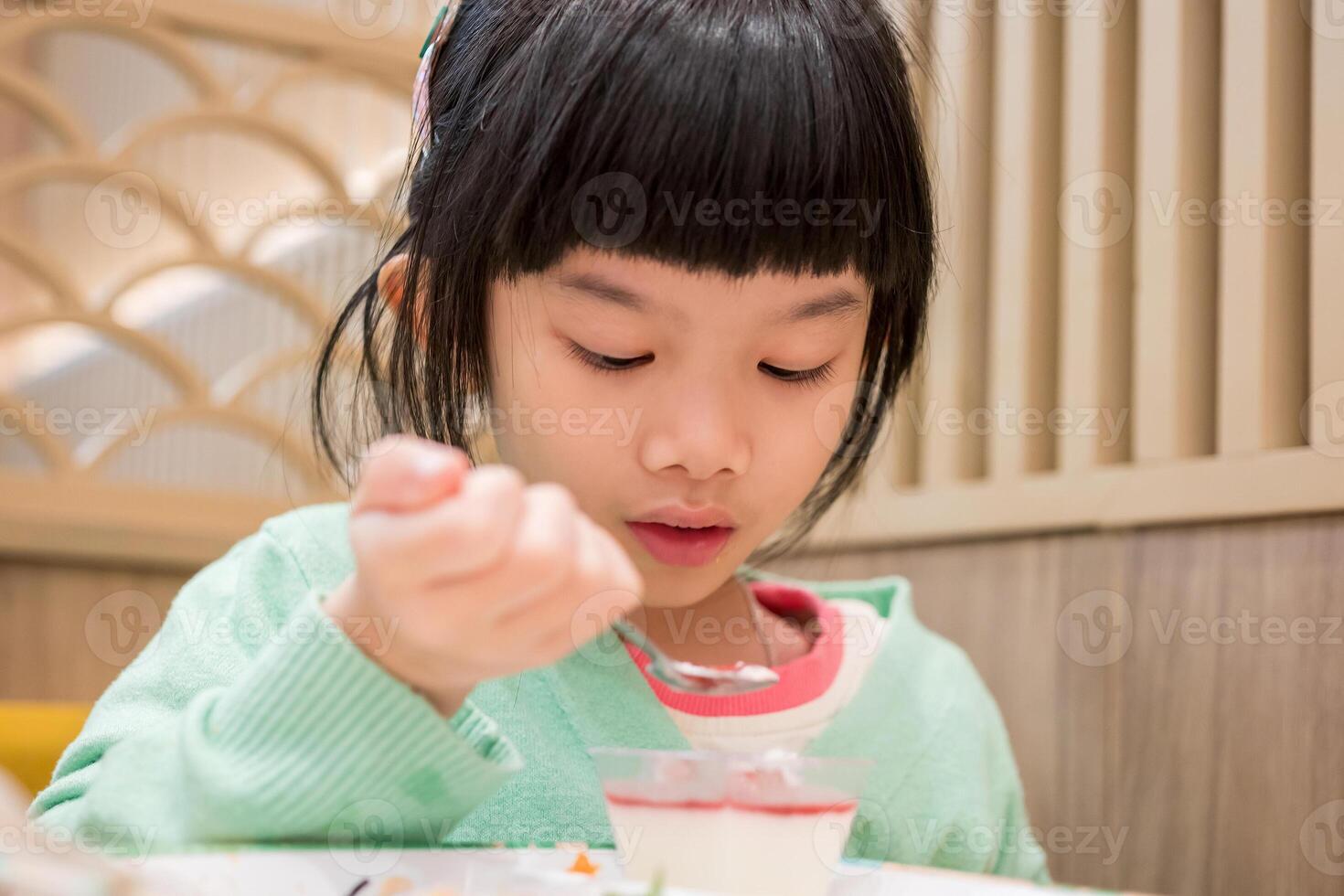 Cute little asian child girl eating food photo