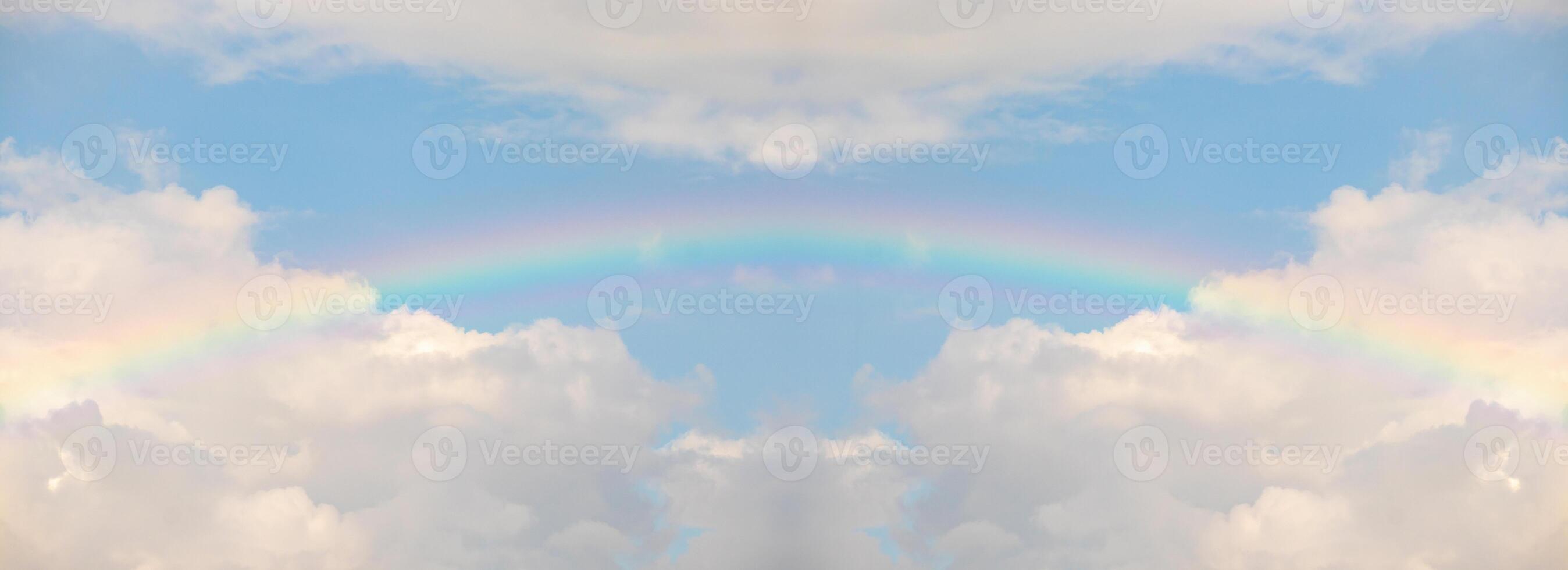 Beautiful rainbow with clouds and blue sky photo