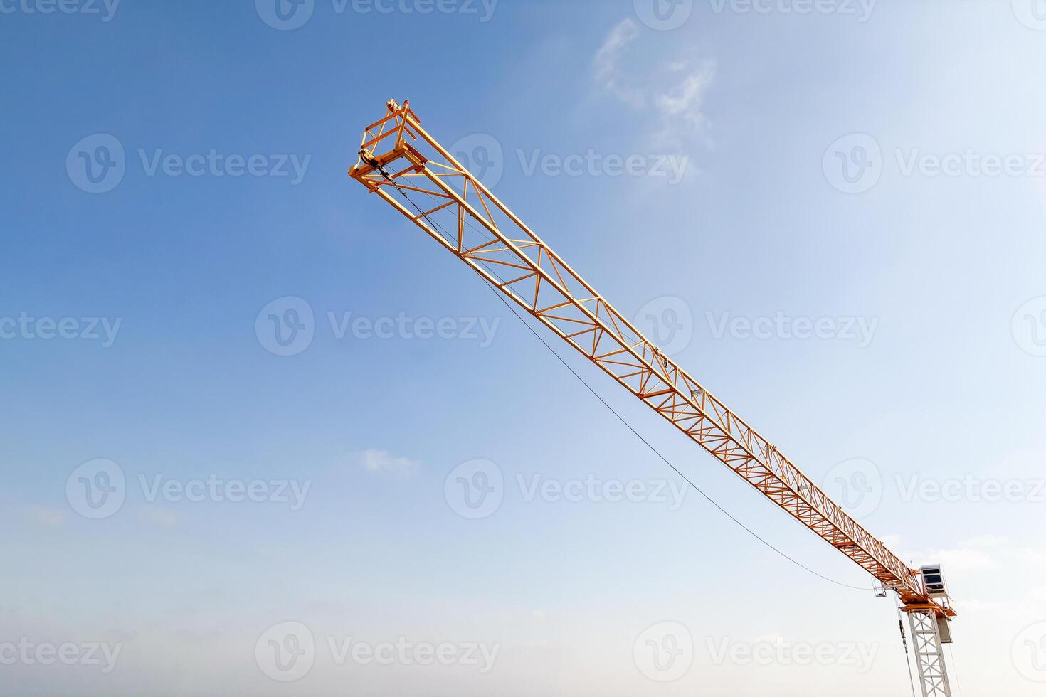 Industrial construction crane with blue sky background at building site photo