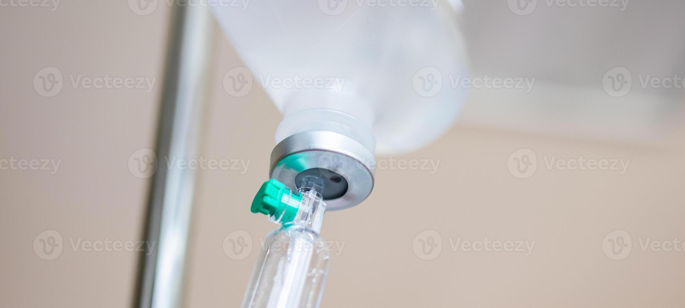 Close up medical intravenous IV drip in hospital background photo