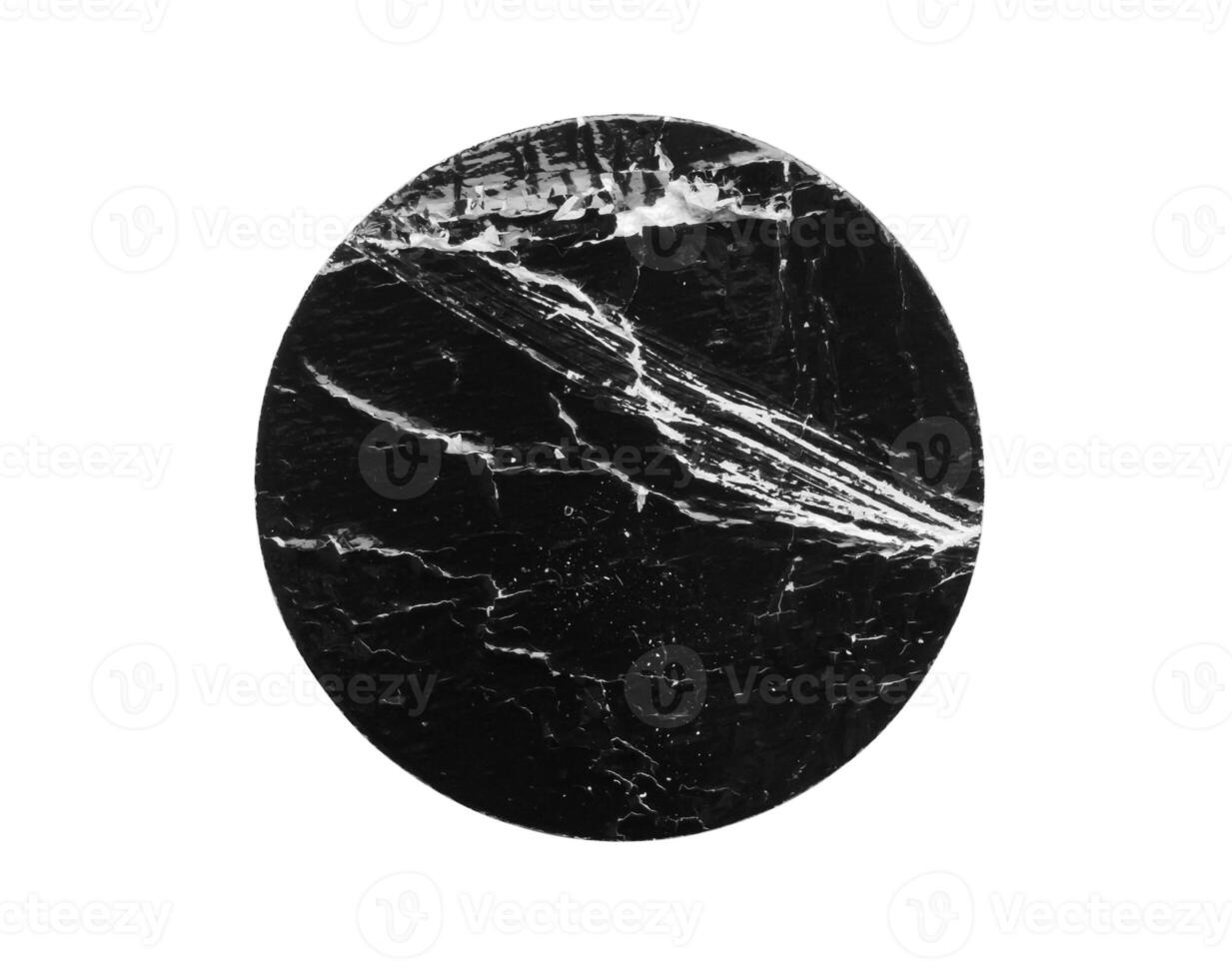 Black old scratched round paper sticker isolated on white background photo