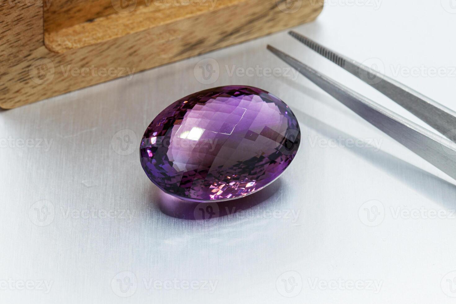 macro mineral faceted stone cut Amethysts on a gray background photo