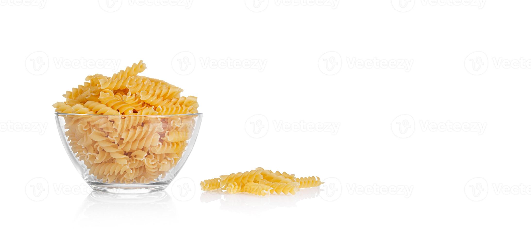 Pasta products in the form of a spiral on a plate, texture, on a white background photo