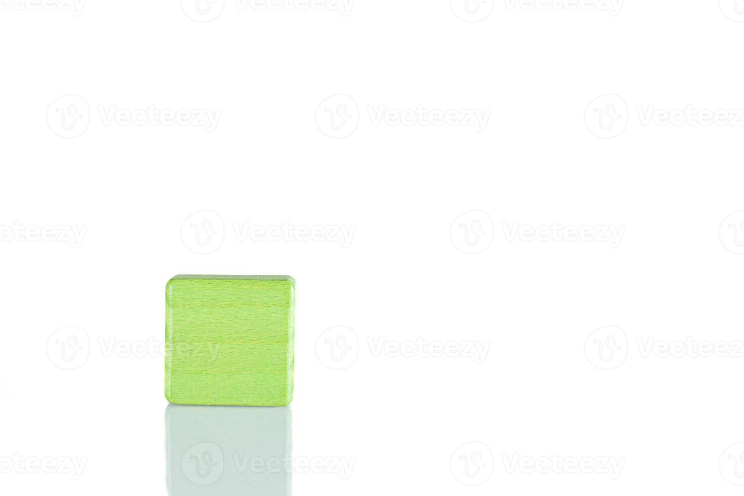 Wooden cube of green color on a white background photo