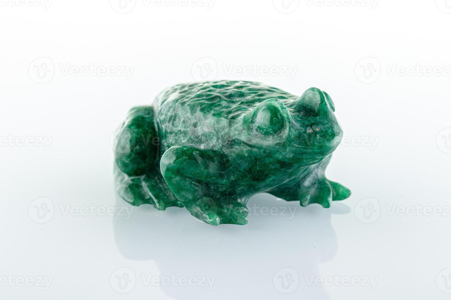 beautiful figurine of a toad made of malachite on a white background photo