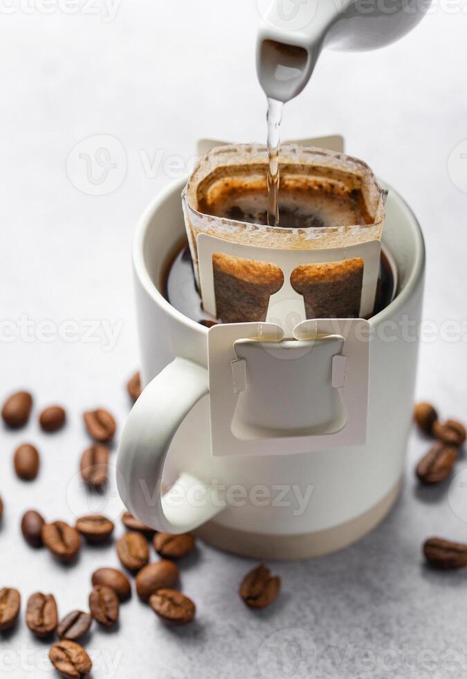 Drip coffee bag with ground coffee in  cup photo