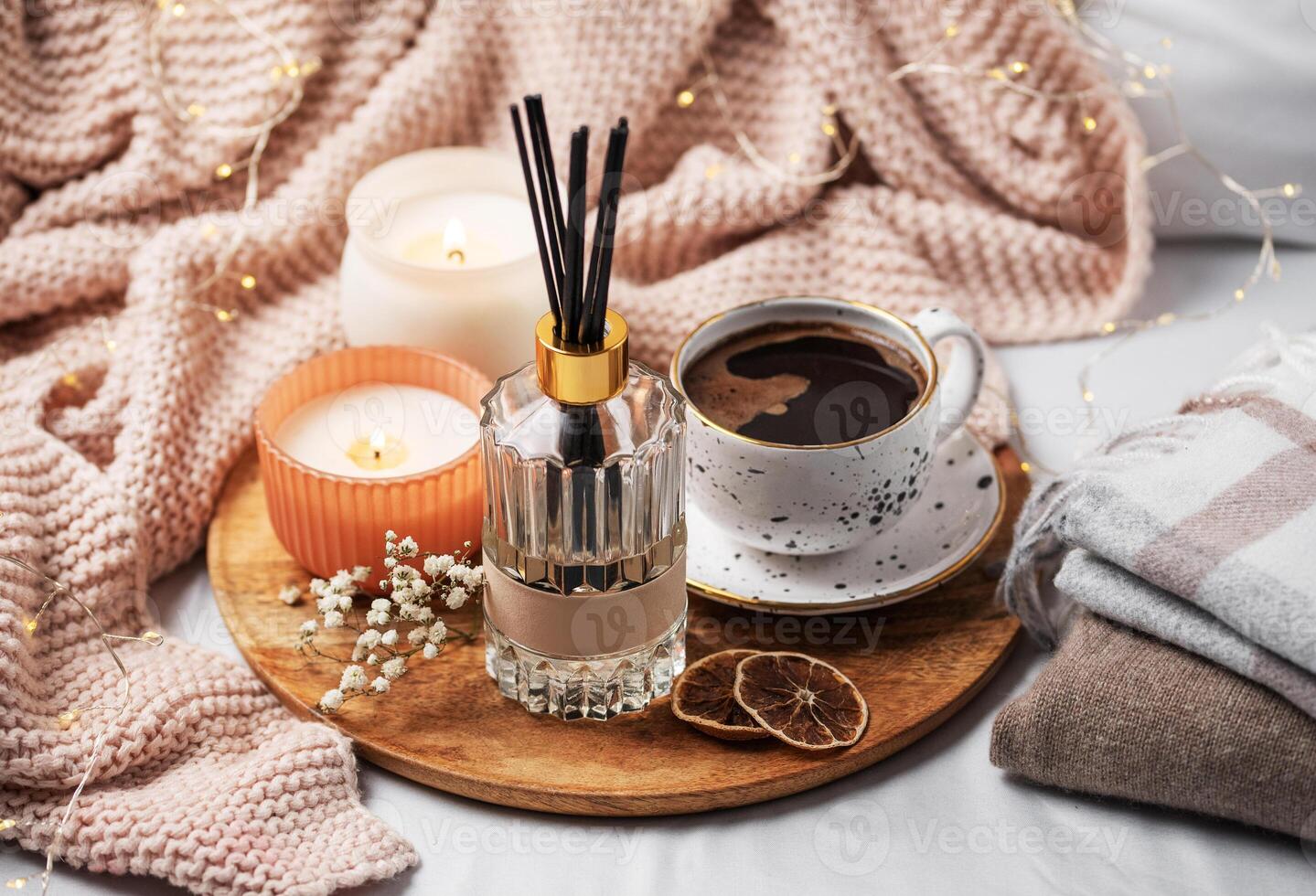 Bamboo sticks in bottle with scented candles and cup of coffee photo