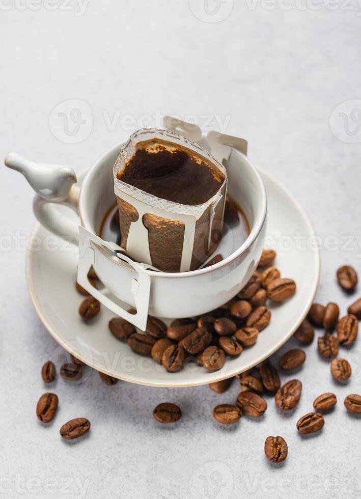 Drip coffee bag with ground coffee in  cup photo