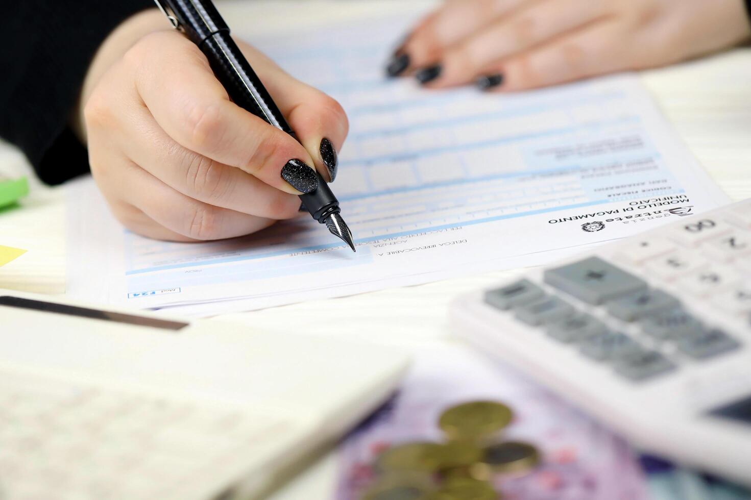 KYIV, UKRAINE - OCTOBER 31, 2023 Accountant fill italian tax form F24 Unified payment model in end of tax period. Taxation and paperwork routine photo