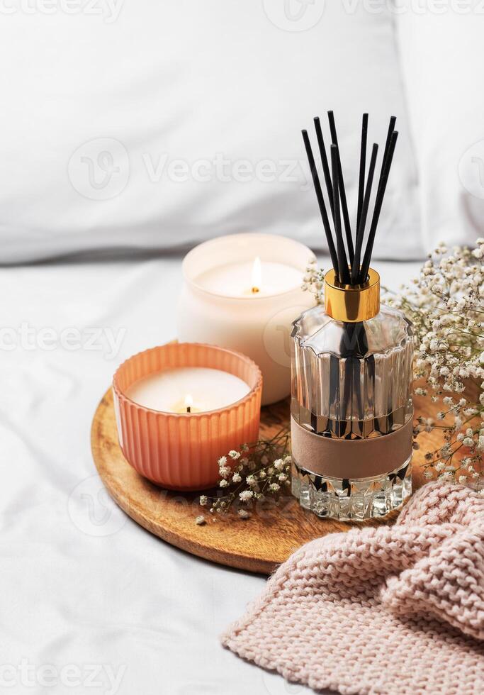 Cozy home atmosphere. Home liquid fragrance in glass bottle photo