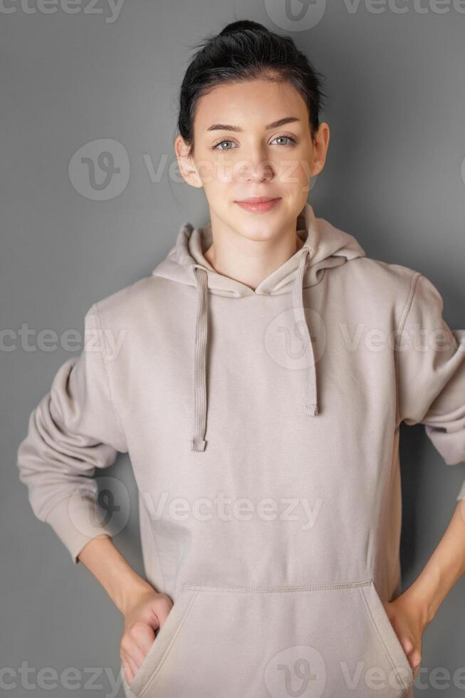 Portrait of a young pretty girl in a  hoodie photo