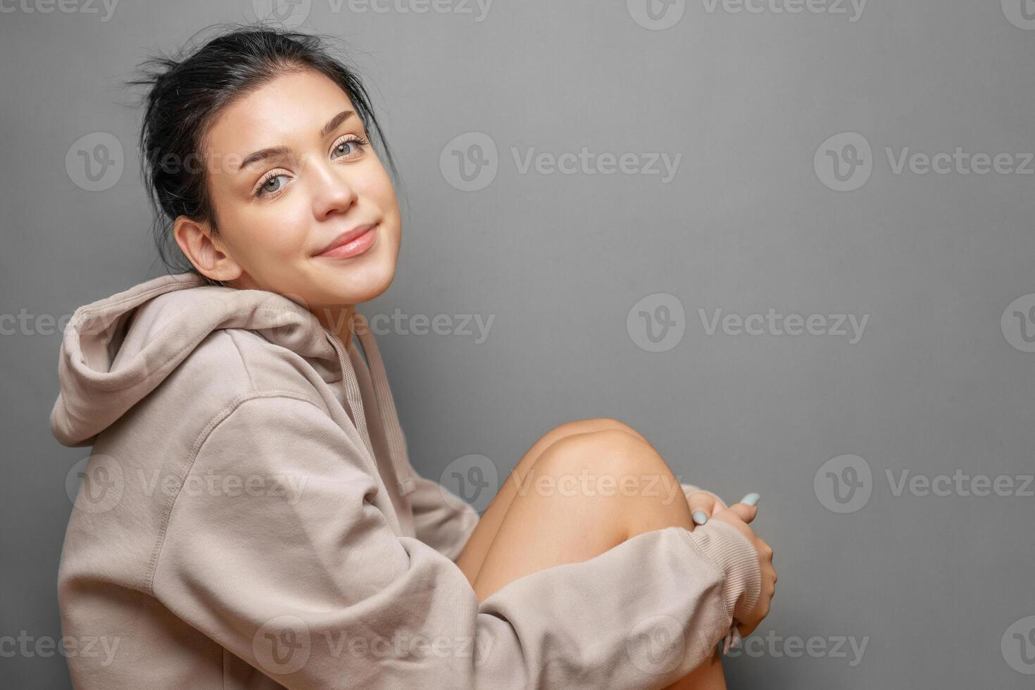 Portrait of a young pretty girl in a  hoodie photo