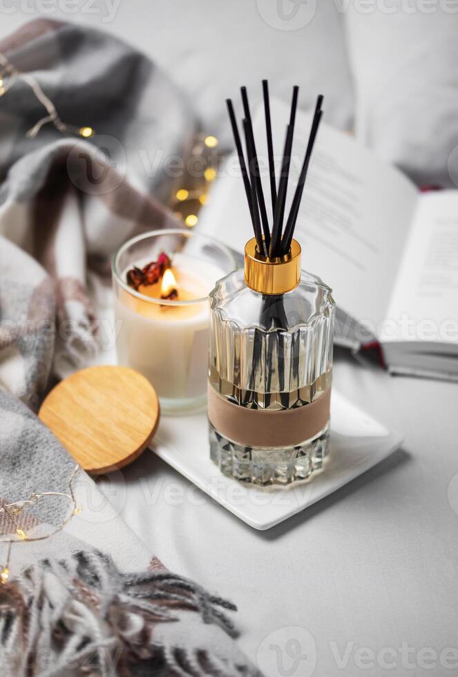 Cozy home atmosphere. Home liquid fragrance in glass bottle photo