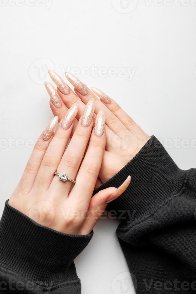 Manicured nails with pearlescent nail polish photo