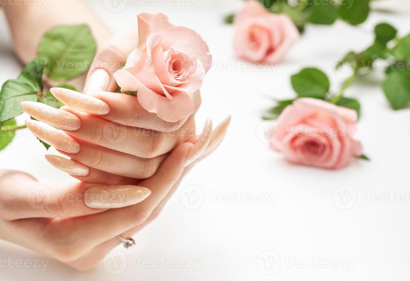 Female Hands on a white background with beautiful pearl manicure photo