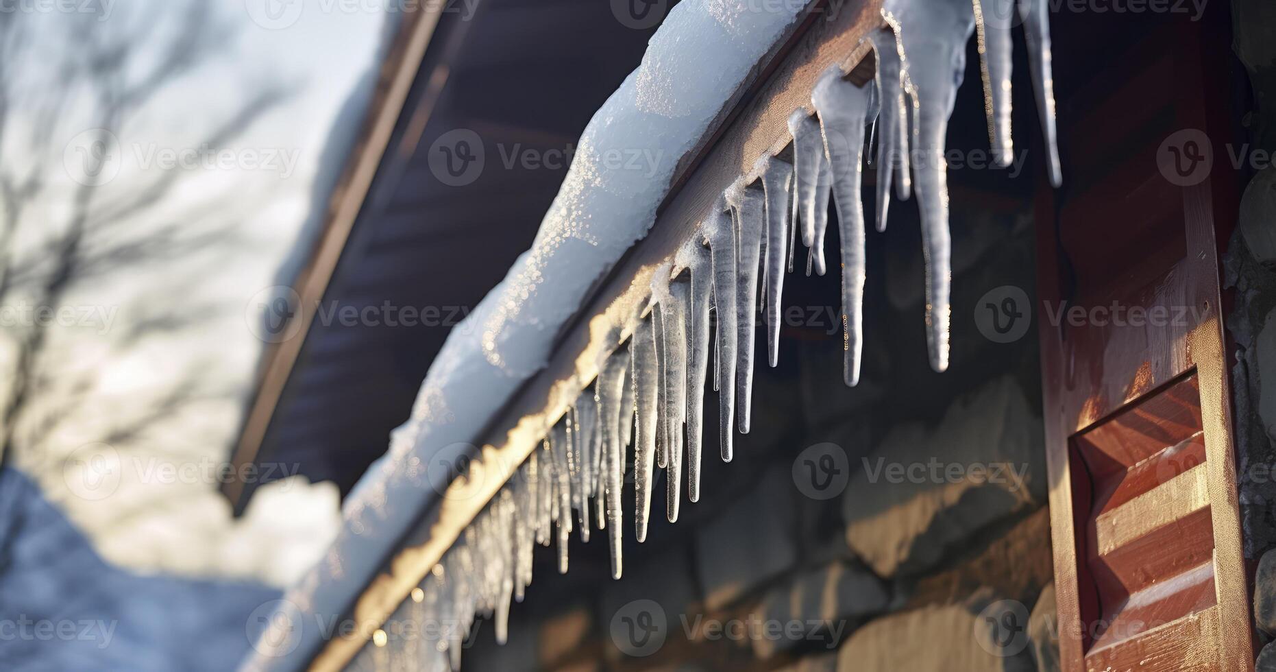 AI generated Frozen dripping water against ceiling lamp of house with stone wall. Spiked icicles at the edge of pitched gray roof with clumps of snow in winter photo