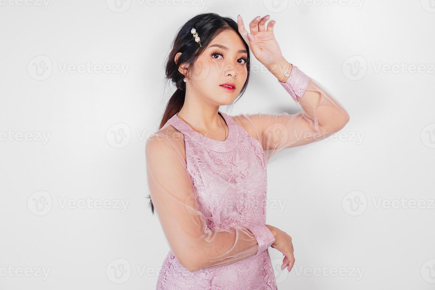 Portrait of a young beautiful Asian woman wearing a pink dress, beauty shoot concept photo