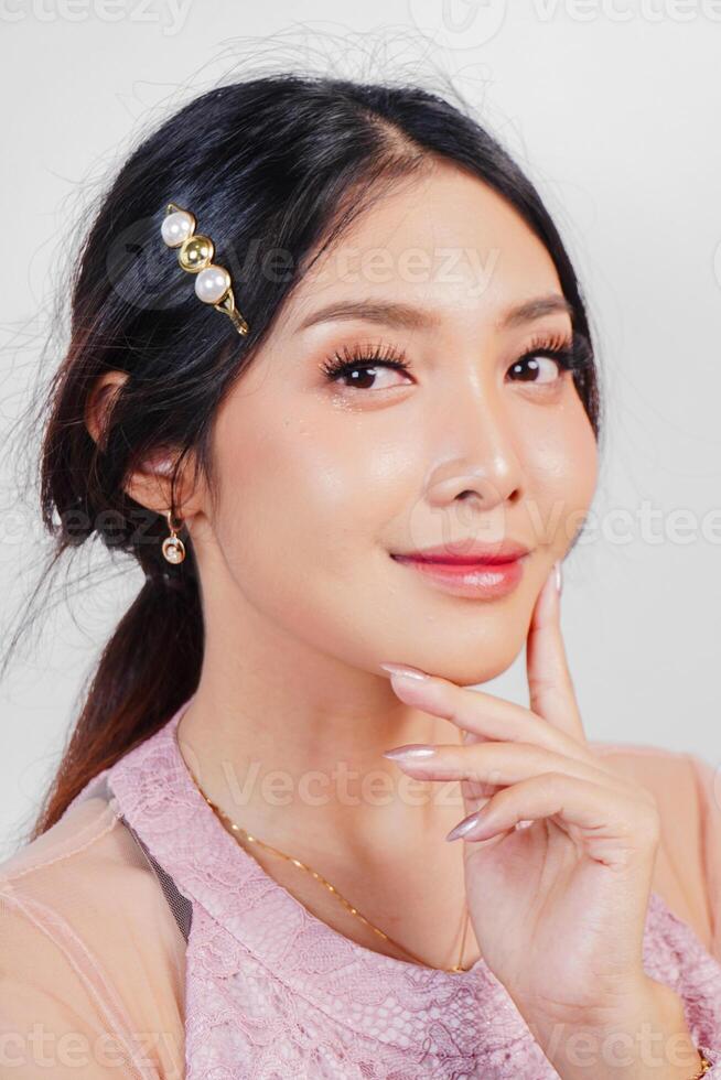 Portrait of a young beautiful Asian woman wearing a pink dress, beauty shoot concept photo