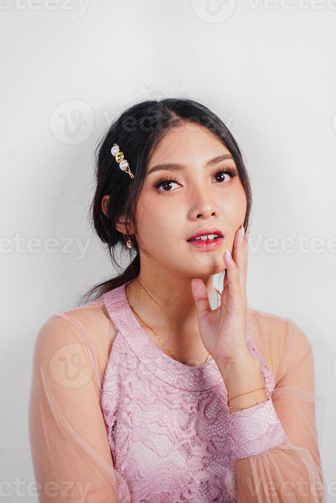 Portrait of a young beautiful Asian woman wearing a pink dress, beauty shoot concept photo