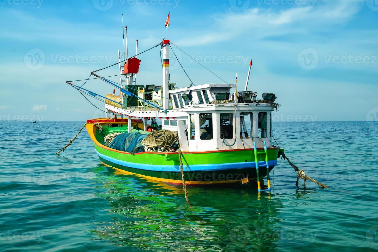 A fishing boat is pulling up on the beach photo