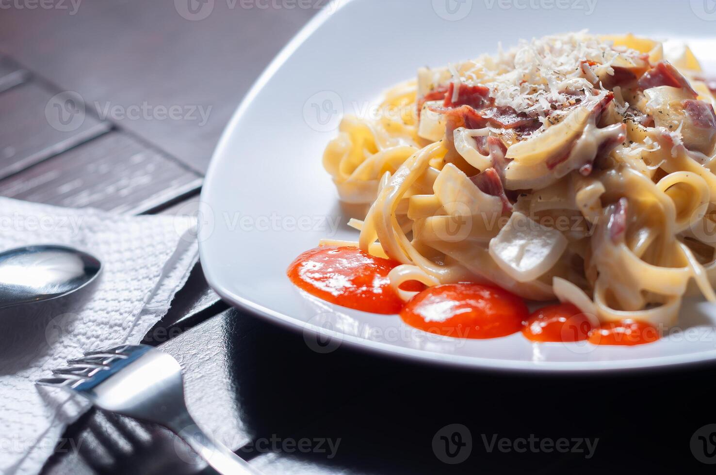 Fettuccine carbonara is pasta made from fettuccine and carbonara sauce photo