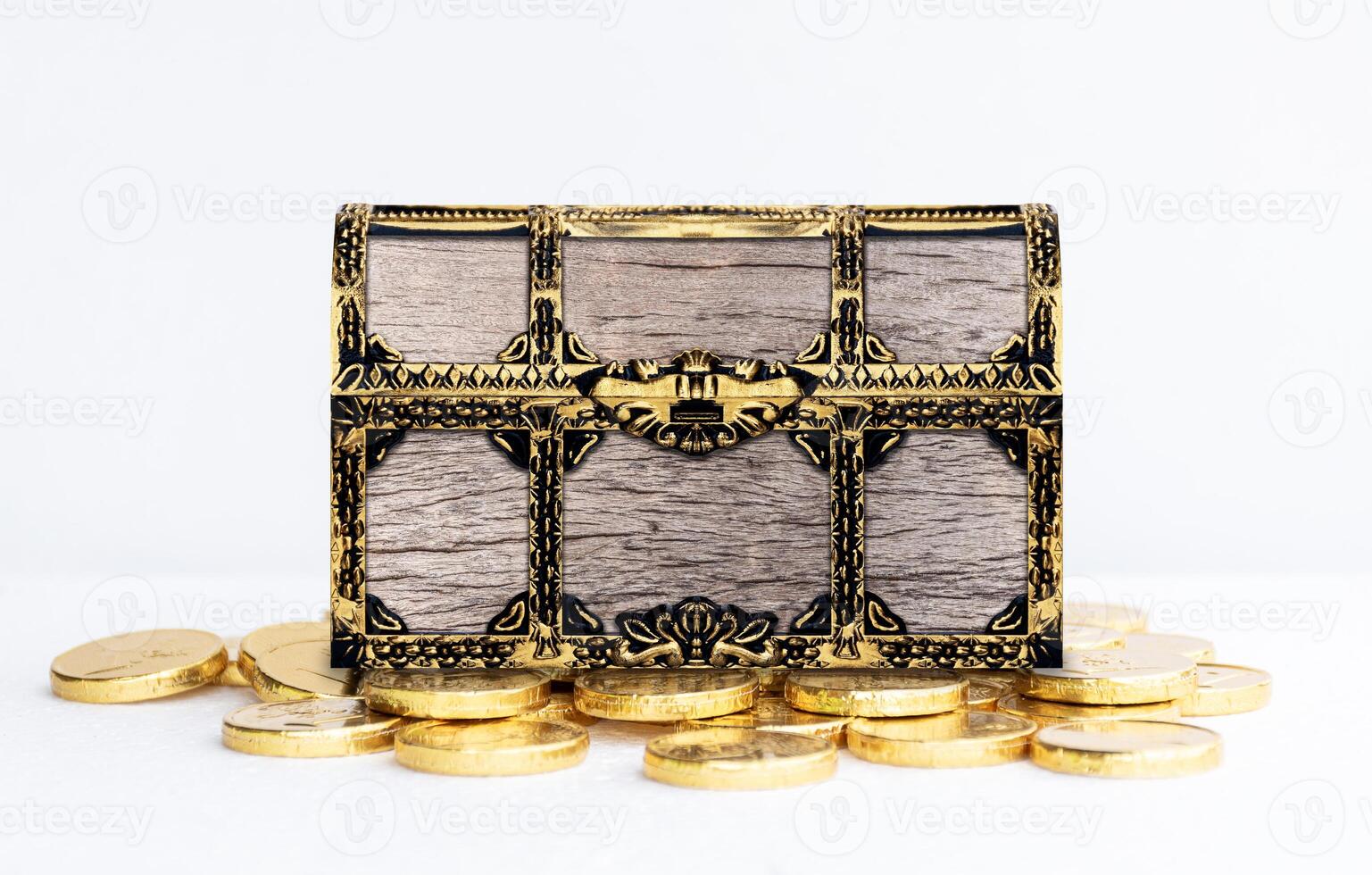 Wooden treasure chest on many golden coin on white background photo