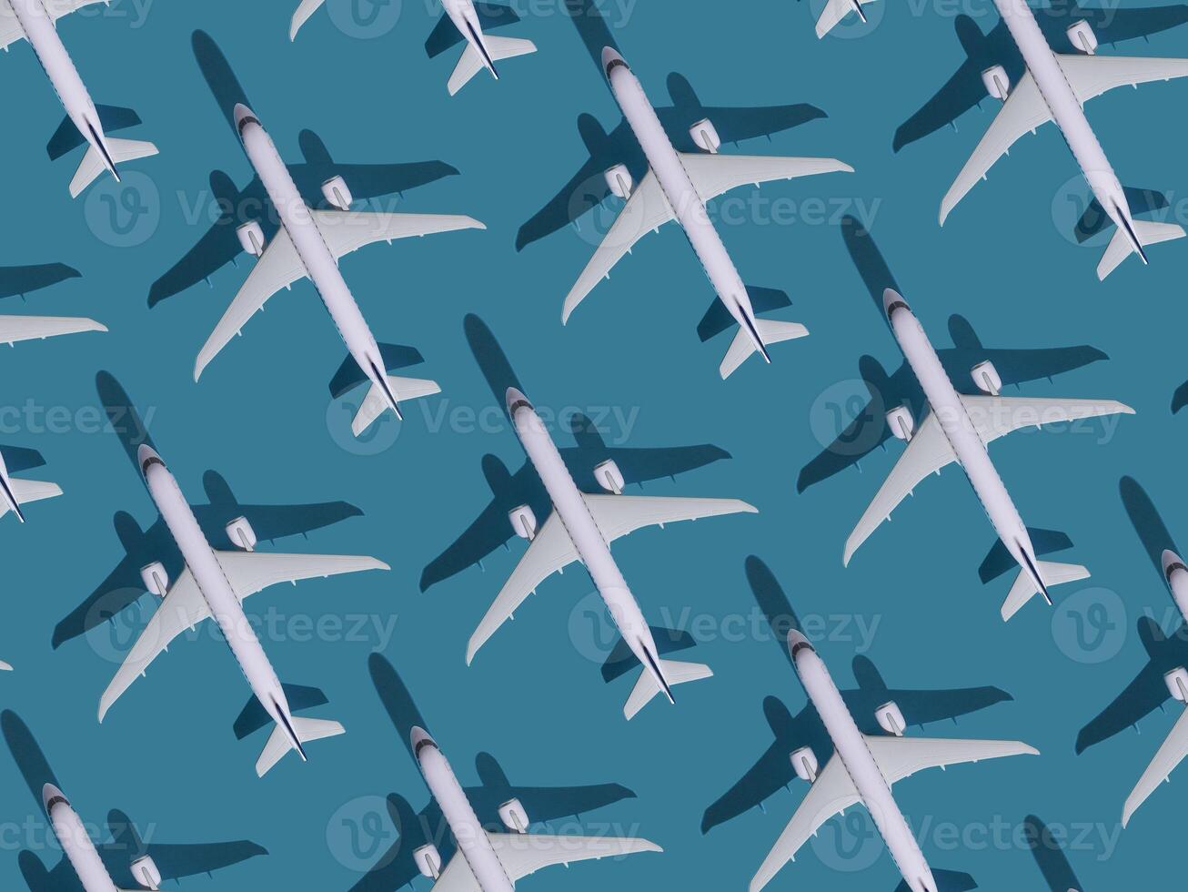 Airplane background. Flights, travel and aviation. Pattern of white planes on a blue background. The passenger plane is flying. Air transport concept photo