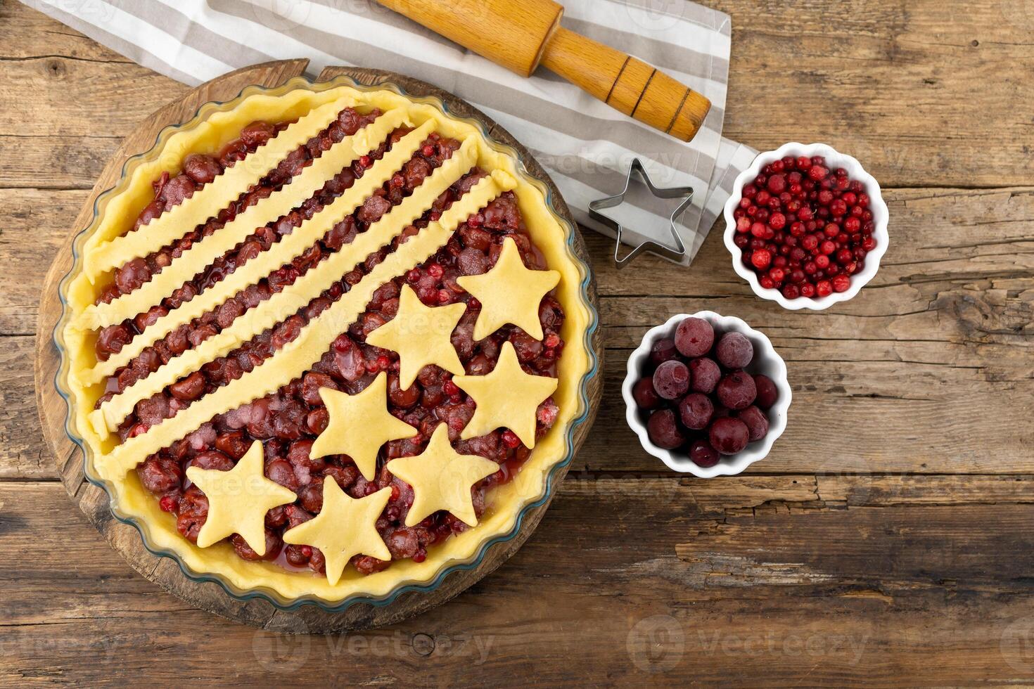 Step 3. Before baking. Homemade cherry pie. Homemade product made from dough with stars. Food for 4th July USA Independence Day. American Pie. Sweet pastries. Berry open round tart photo