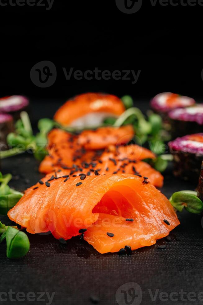 Sliced Fresh Salmon plate on black background. Salmon sashimi with black sesame, with copy space. High quality photo