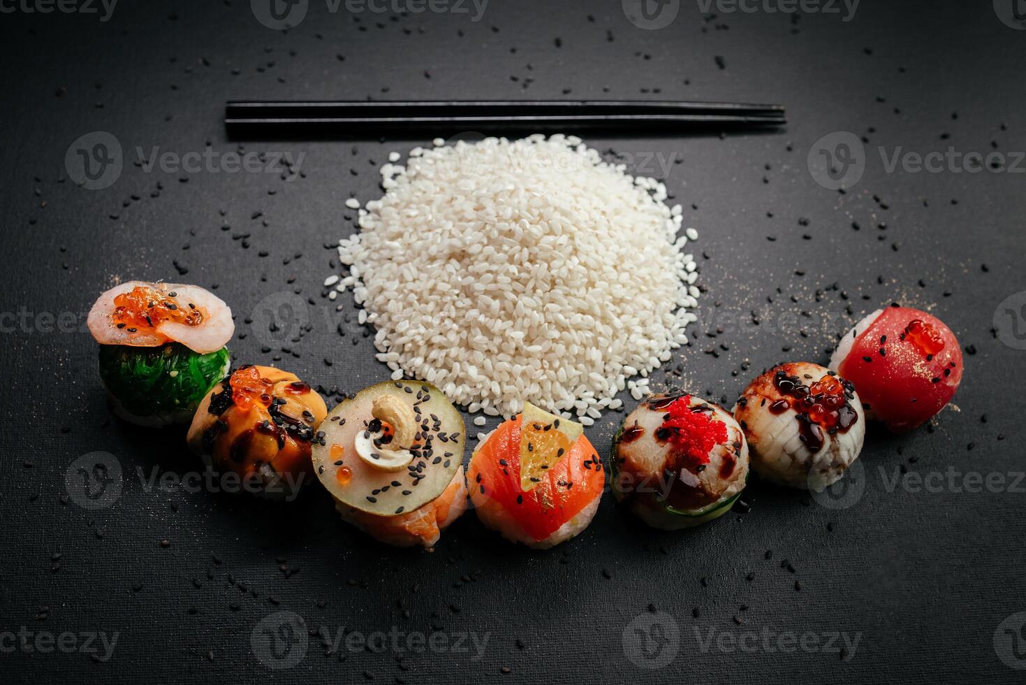 Elegance meets flavor as sushi varieties take their place on a black background, inviting connoisseurs to partake in a visual and gustatory feast at restaurant photo
