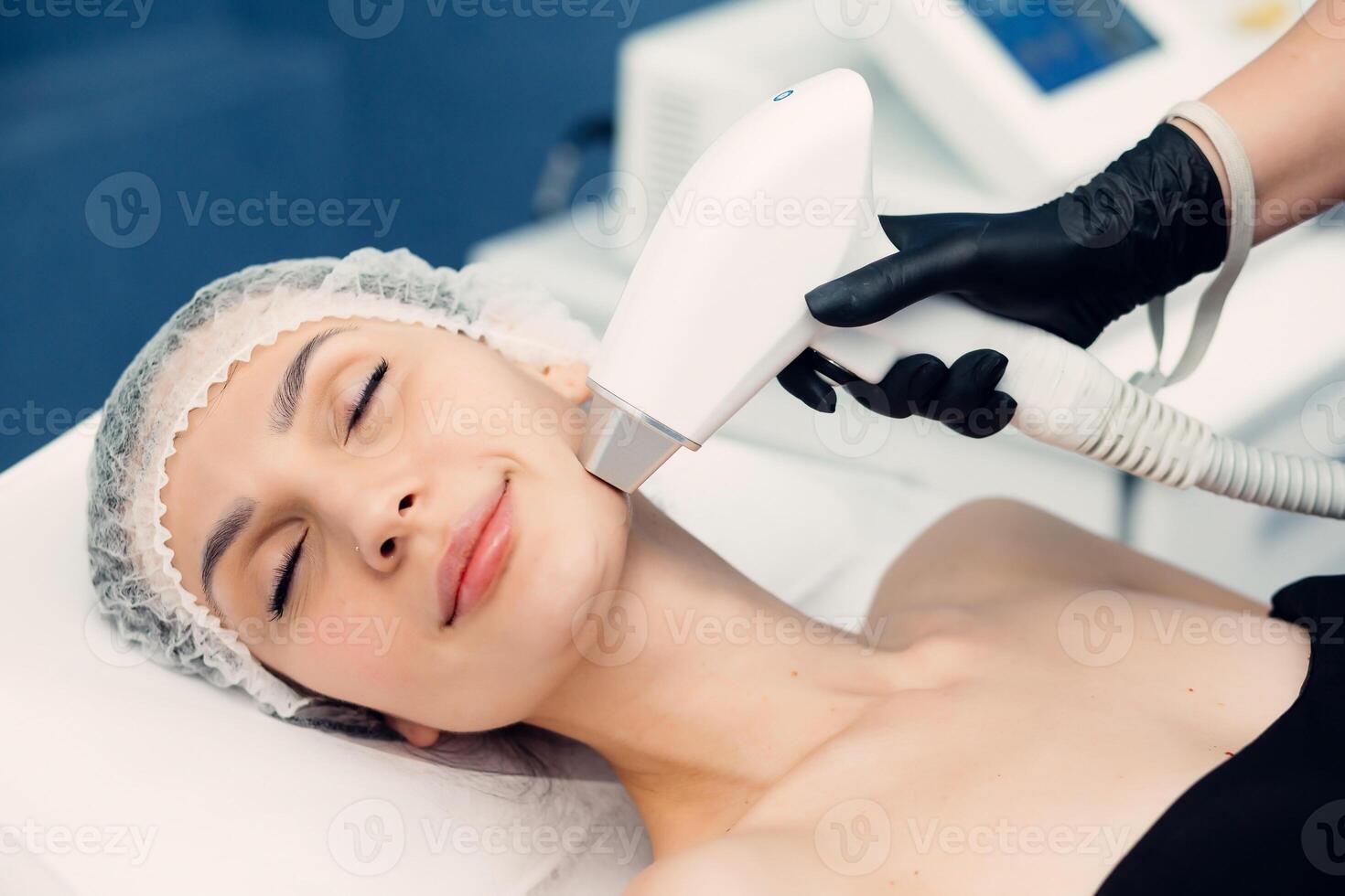 Body care concept. Laser hair removal. Young Caucasian woman lies on the sofa, female cosmetologist doing laser face hair removal in a beauty salon. Girl on mustache laser hair removal procedure. photo